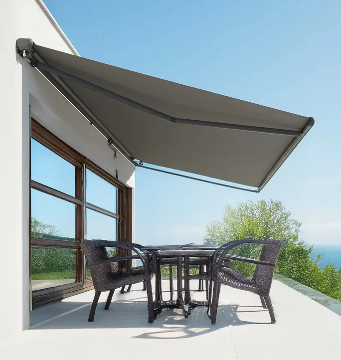 Folding arm awning over an outdoor setting