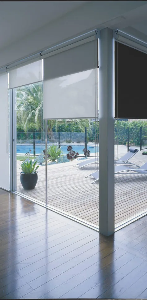 Roller blinds on floor-to-ceiling windows