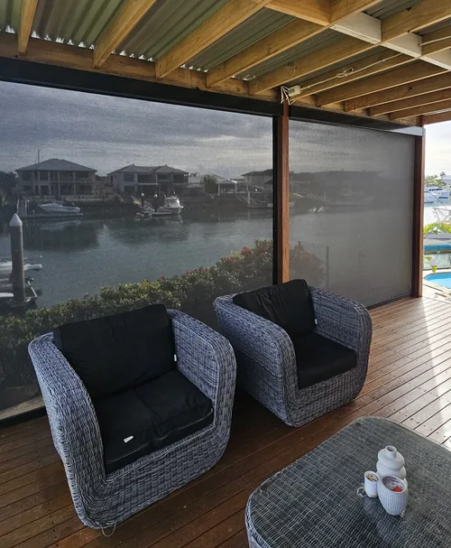 Outdoor blinds around a covered deck overlooking a canal