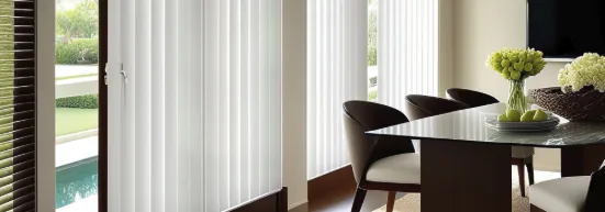 Vertical blinds on sliding doors beside a dining table