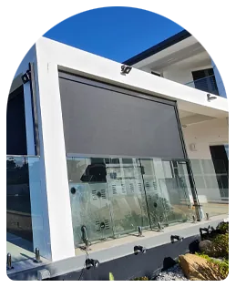 Outdoor blinds on a balcony with glass balustrade