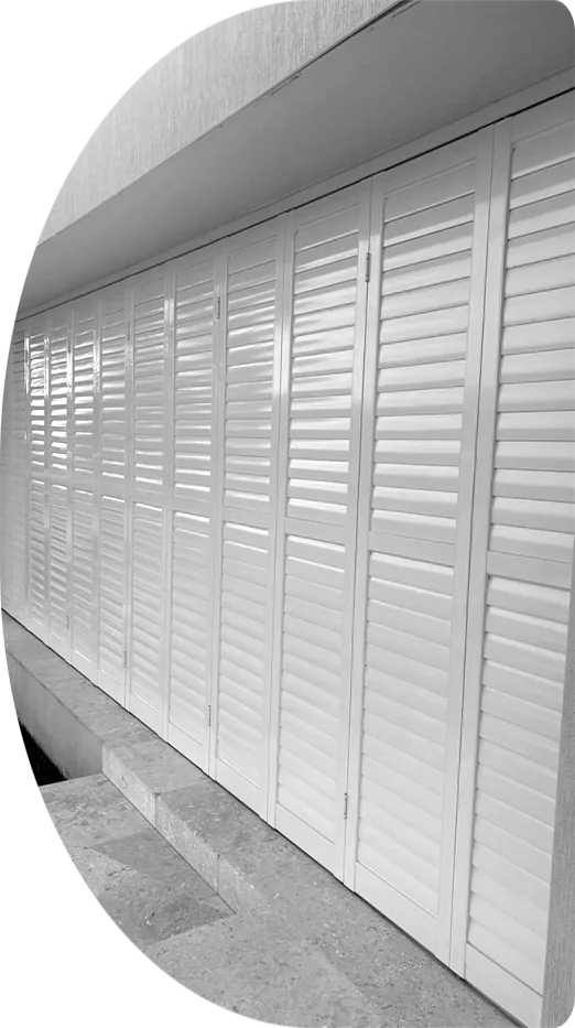 White outdoor shutters along a patio