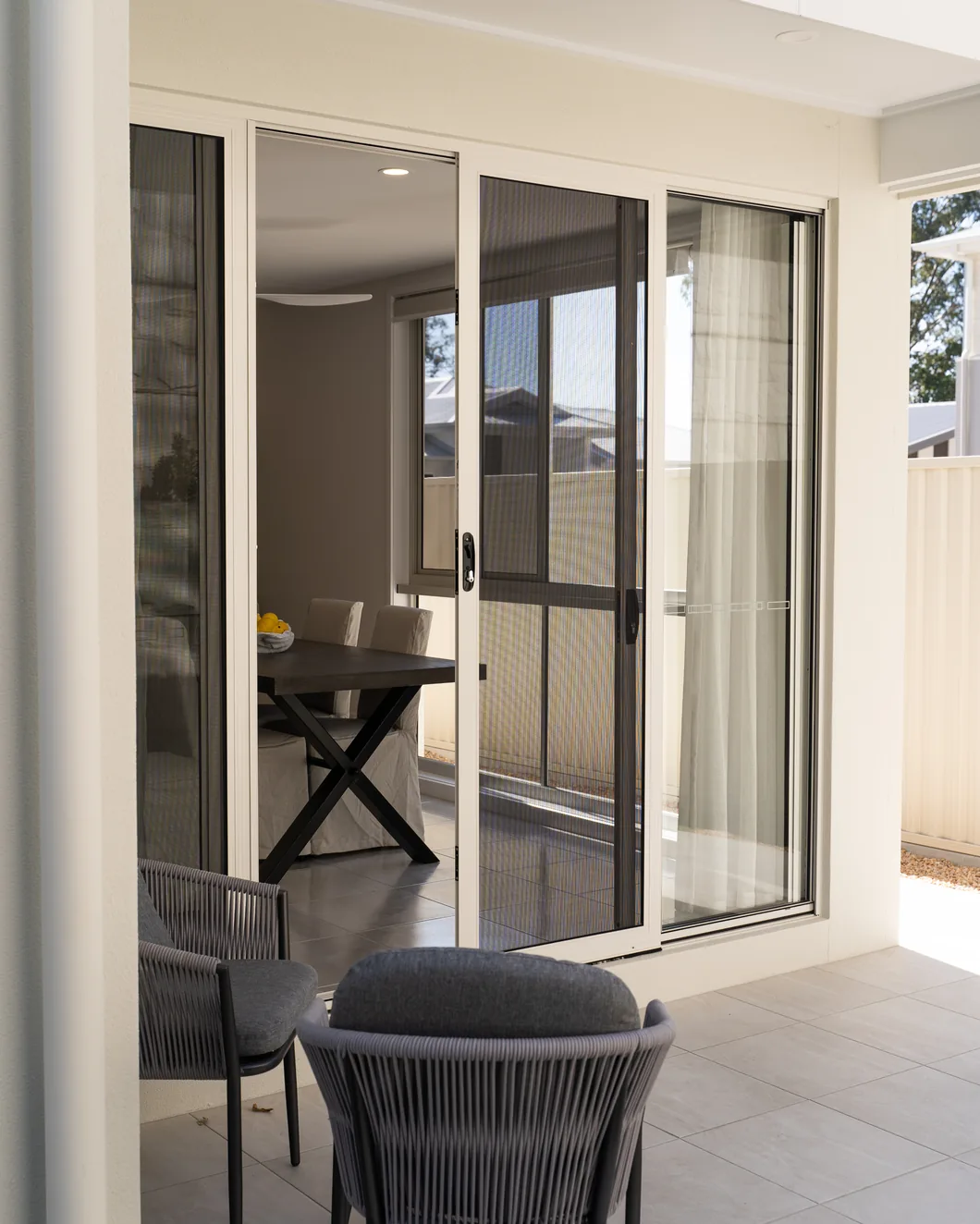 Sliding security screen doors in an open-plan living area