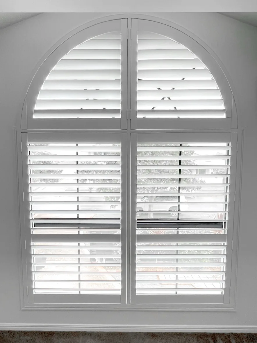 Plantation shutters on an arched window